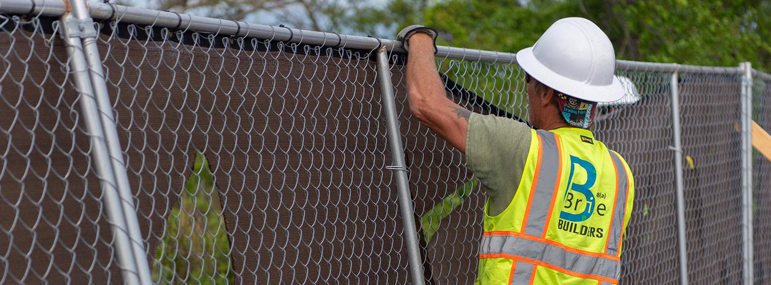 Man working on chain link fence